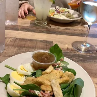 I always substitute my house garden salad for a spinach salad with hot bacon dressing.