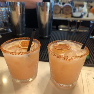 two cocktails on a bar