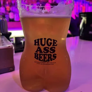 a glass of beer on a bar counter