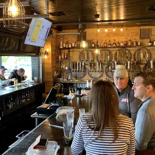 a group of people sitting at a bar