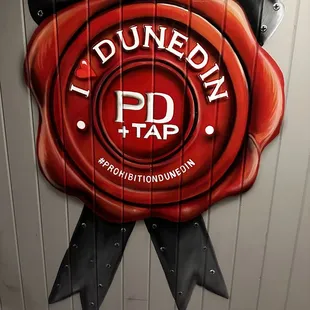 a red wax seal on a wall