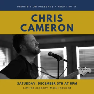 a black and white photo of a man singing into a microphone