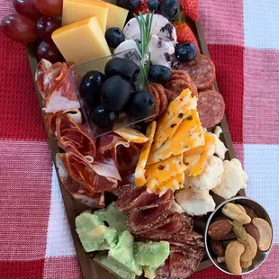 Signature charcuterie board with a tantalizing medley of meats &amp; cheeses from Amazing Graze.