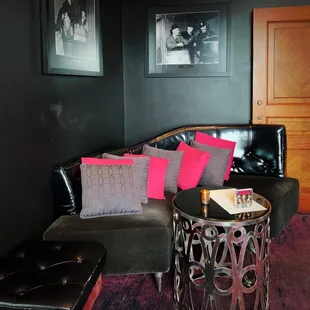 a living room with a couch, chair, and ottoman