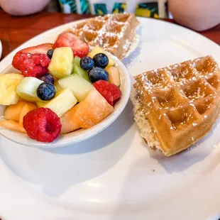 a waffle, fruit salad, and coffee