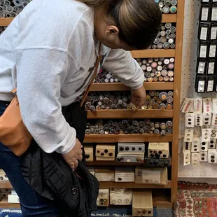 Kikki looking through the plethora of beautiful buttons.