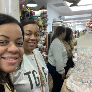 My sister and I posing. In the back of THE STIRE WOTH SOME GORGEOUS PINK AND BLUE fabric.