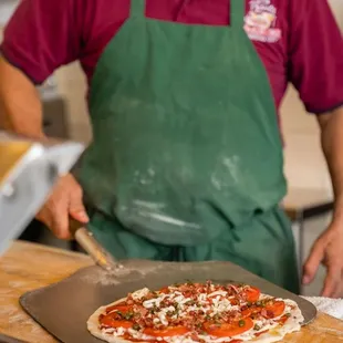 a man preparing a pizza