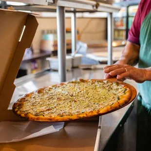 a man holding a pizza
