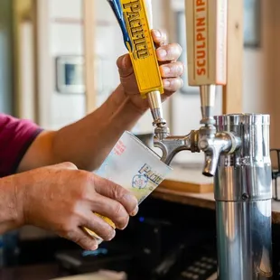 a man pouring a beer