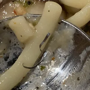 Wire scrub brush material. This gives you an idea of how little care they have with food safety.