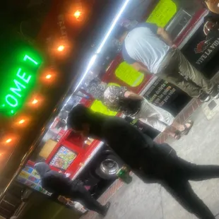 a man standing in front of a neon sign