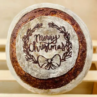 the word merry christmas written on the side of a loaf of bread