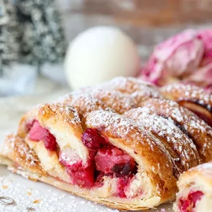 a pastry with raspberry filling and powdered sugar