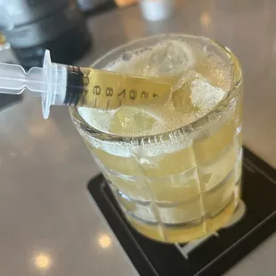 a glass of lemonade with a measuring tape