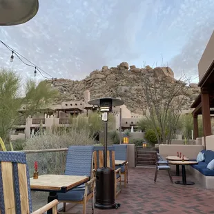 a patio with a mountain in the background