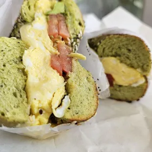 Pesto and egg breakfast sandwich on spinach everything