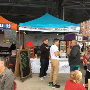 a group of people standing under a tent