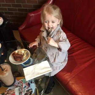 My little girl Amelia eating a cinnamon roll!