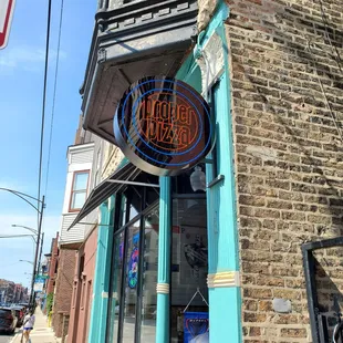 a brick building with a neon sign