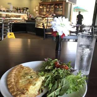 Quiche Lorraine and side salad with bacon and cherry tomatoes with sweet vinaigrette dressing.