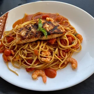 Salmon over tomato basil fettuccine