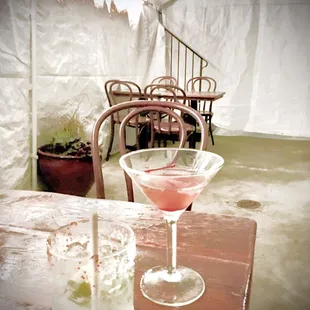 a glass of cocktail on a table