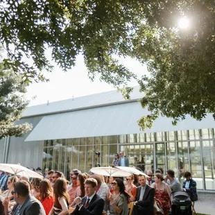 Guest at a summer wedding ceremony on the lawn