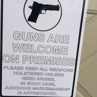 a sign that reads guns are welcome on premises