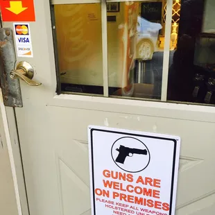 a sign on a door that reads guns are welcome on premises