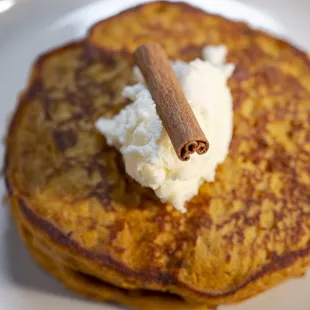 pumpkin buttermilk pancakes served with honey-pecan butter and maple syrup