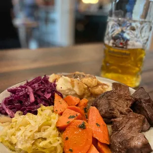 a plate of food and a glass of beer