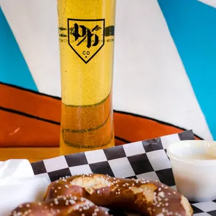 a plate of pretzels and a glass of beer