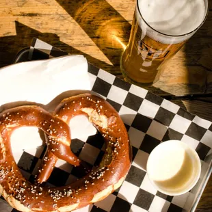 a pretzel and two cups of beer