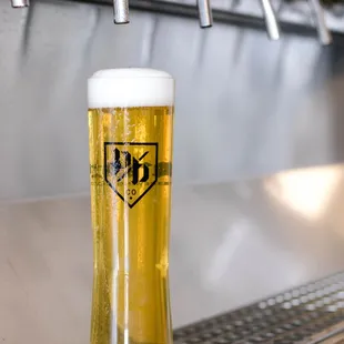 a pint of beer on a bar