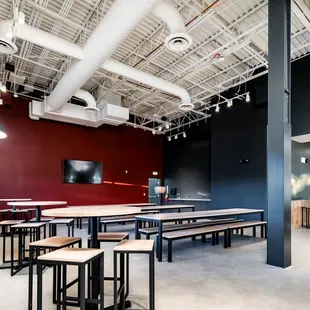 a large room with tables and benches
