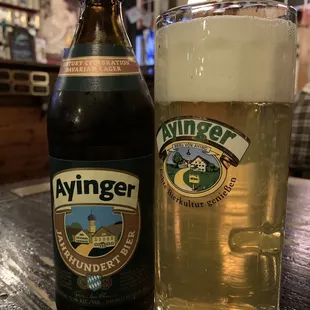 a glass and a bottle of ayinger