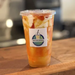 a plastic cup of fruit smoothie