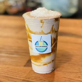 a cup of iced coffee on a table