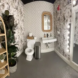 a woman taking a selfie in a bathroom