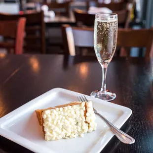 a piece of cheesecake and a glass of champagne