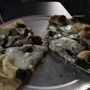 The Pontiff Pie. Olive oil, garlic, fresh spinach, roasted tomatoes, mozzarella and feta cheese. Super tasty!