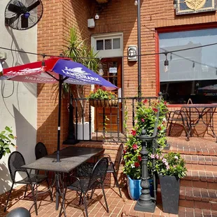 a patio with tables and umbrellas