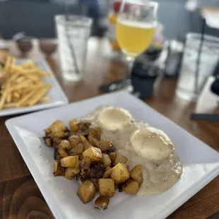 Country benedict with gravy sauce and a mimosa.