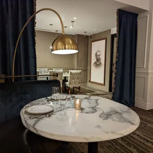 Dining room, nice two-person table, large format seating behind.