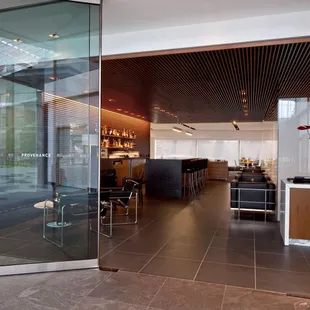 a glass door leading to a bar