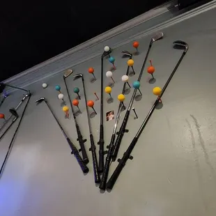 a bunch of golf clubs on a table