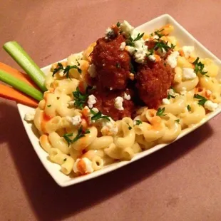 BUFFALO MAC - boneless chicken wings served on top mac &amp; cheese dressed with blue cheese and spicy wing sauce!
