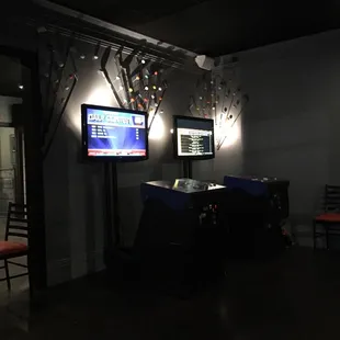 two televisions in a dimly lit room