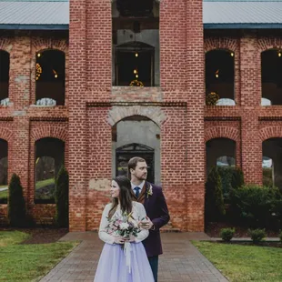 Couple standing in front of providence cotton mill